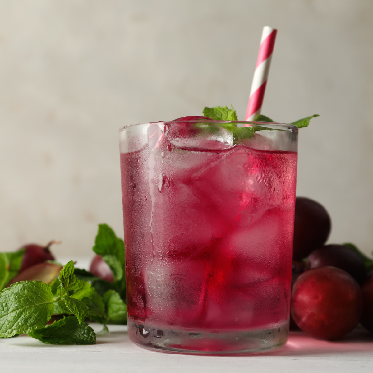 Chilled grape cocktail with ice, fresh mint and grapes