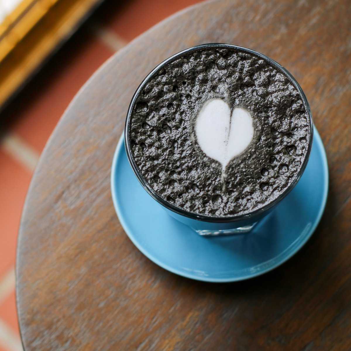 black sesame latte with milk foam art for café beverage and dessert presentation