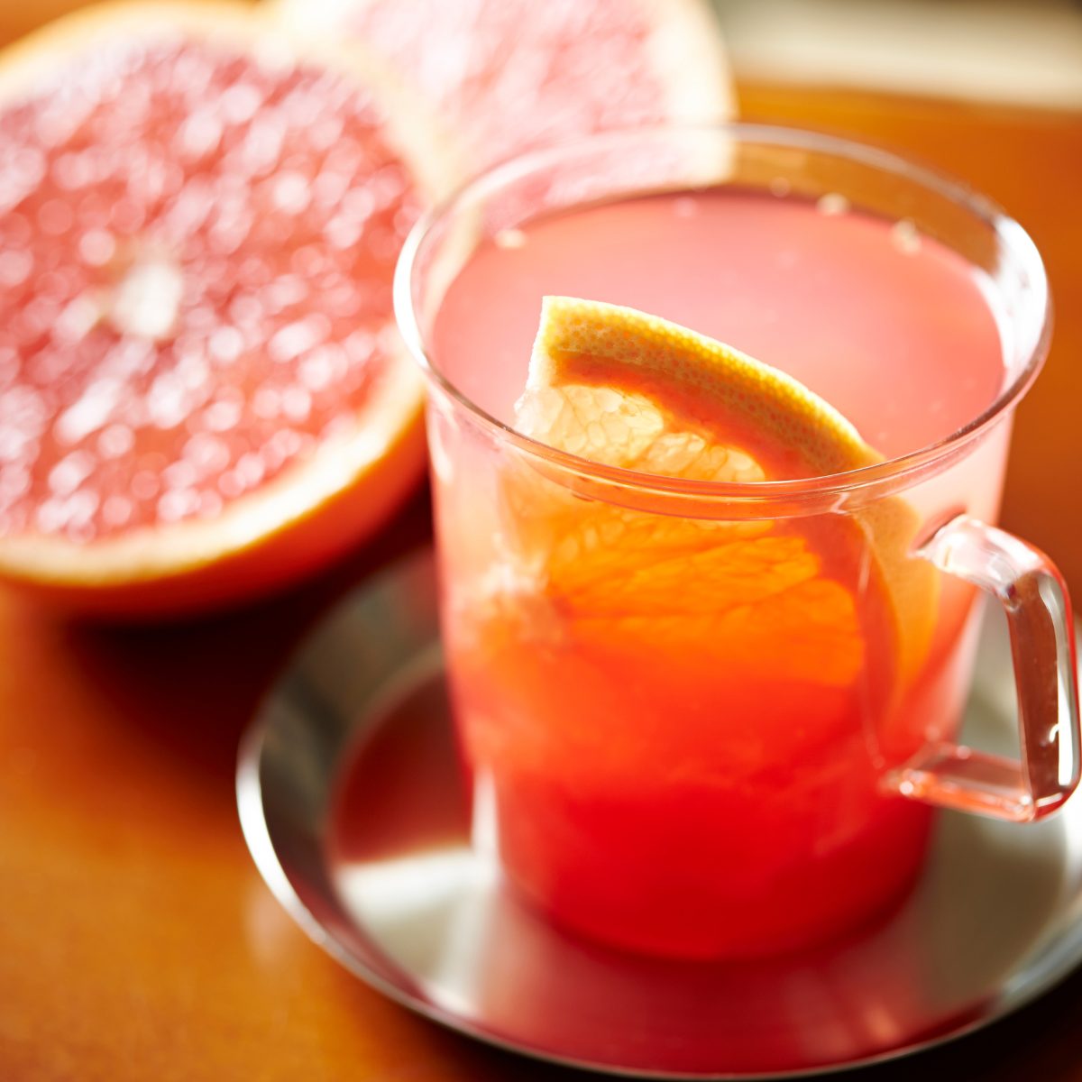 Refreshing grapefruit tea made with grapefruit syrup featuring vibrant citrus notes and fresh grapefruit garnish
