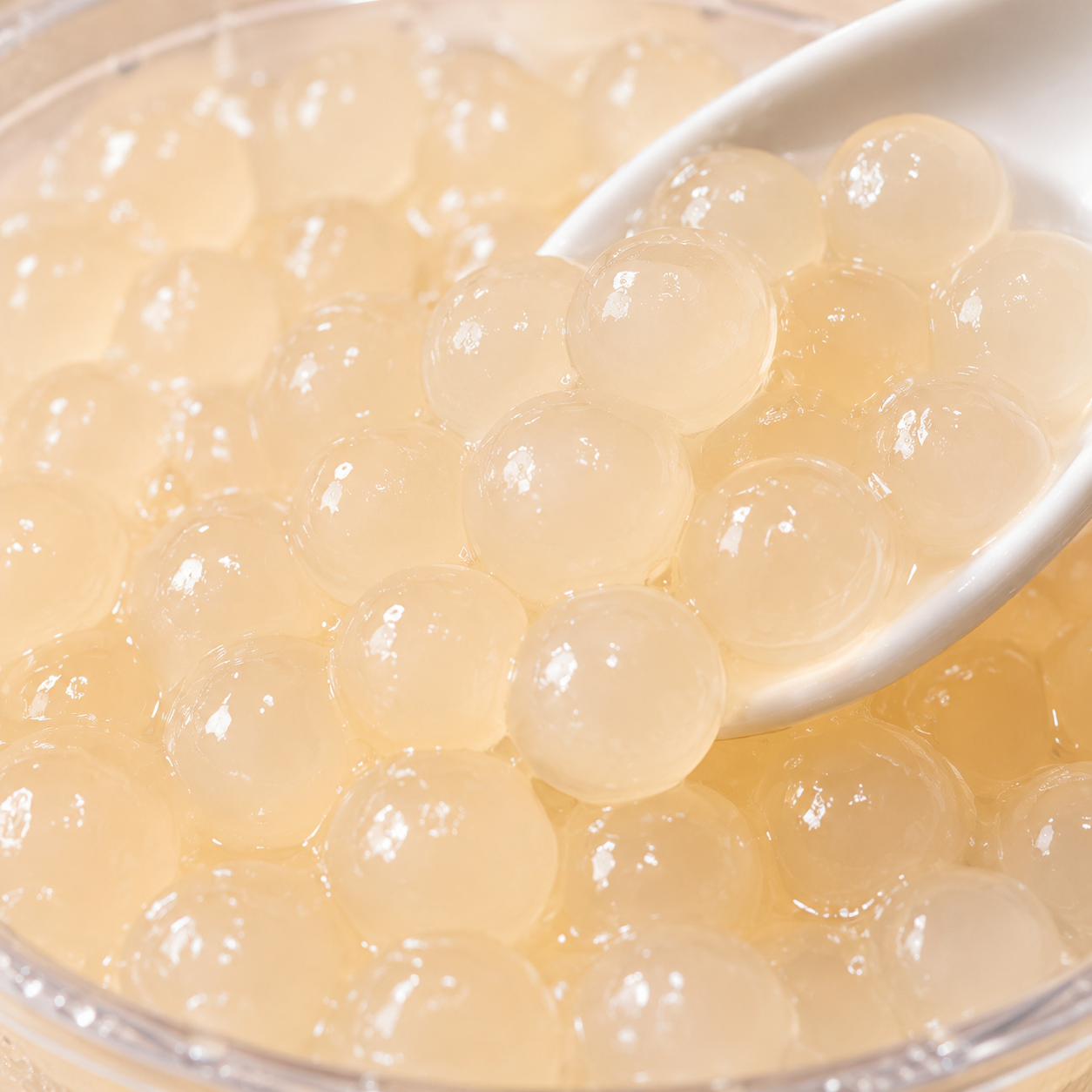 Close-up of Litchi Frubo Popping Boba featuring juice-filled bursting pearls with authentic lychee flavor and glossy texture for bubble tea shops