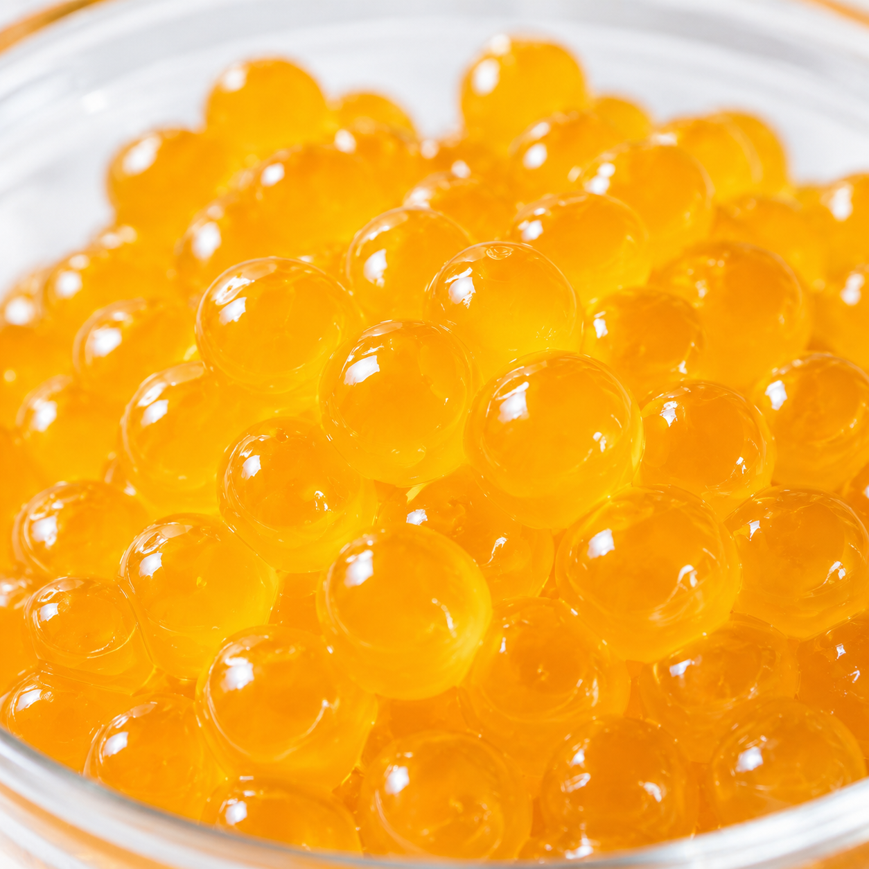Close-up of Mango Crystal Boba translucent agar pearls with chewy texture and tropical mango flavor